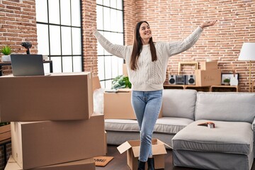 Wall Mural - Young woman standing with arms open at new home