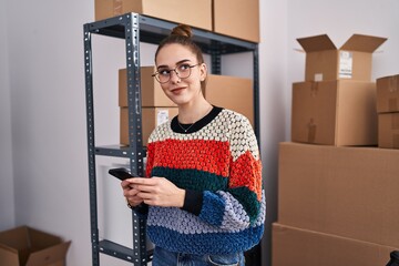 Wall Mural - Young woman ecommerce business worker using smartphone at office