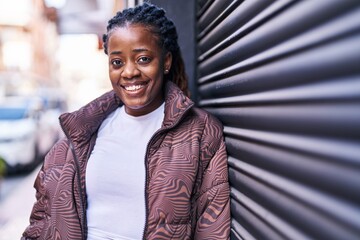 Wall Mural - African american woman smiling confident standing at street