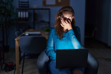 Sticker - Brunette woman working at the office at night tired rubbing nose and eyes feeling fatigue and headache. stress and frustration concept.