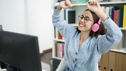 Poster - Young beautiful hispanic woman student listening to music dancing at library university