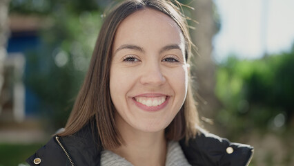 Wall Mural - Young beautiful hispanic woman smiling confident standing at park