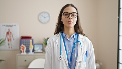 Sticker - Young beautiful hispanic woman doctor standing with serious expression at clinic