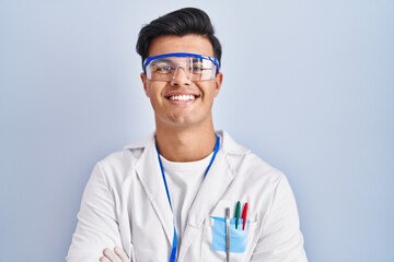 Sticker - Hispanic man working as scientist happy face smiling with crossed arms looking at the camera. positive person.