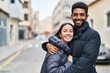 © Krakenimages.com - Man and woman couple smiling confident hugging each other at street