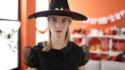 Sticker - Young blonde woman wearing witch costume at home