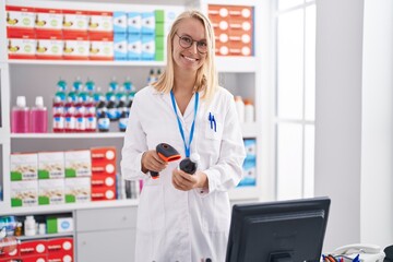 Canvas Print - Young blonde woman pharmacist scanning medication bottle at pharmacy