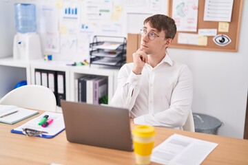 Sticker - Young caucasian man business worker using laptop with doubt expression at office