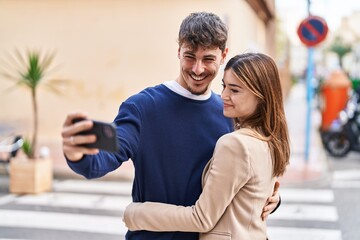 Poster - Mand and woman couple hugging each other make selfie by smartphone at street