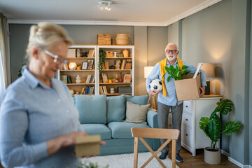 Wall Mural - Senior couple man and woman husband wife pack or unpack boxes moving