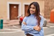 © Krakenimages.com - Young hispanic woman smiling confident standing with arms crossed gesture at street