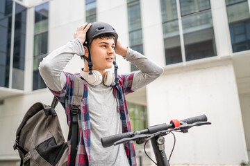 Young man caucasian teenager with electric kick push scooter in city