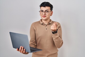 Wall Mural - Non binary person using computer laptop doing money gesture with hands, asking for salary payment, millionaire business