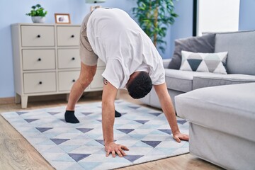 Sticker - Young arab man stretching at home