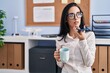 © Krakenimages.com - Young caucasian woman business worker talking on smartphone drinking coffee at office