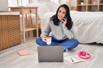 Poster - Young caucasian woman student talking on smartphone drinking coffee at bedroom