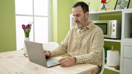 Sticker - Middle age man using laptop sitting on table at home