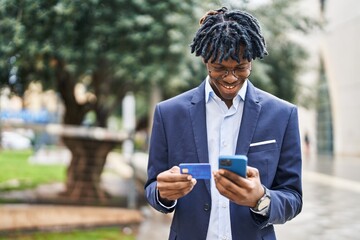 Poster - African american man executive using smartphone and credit card at park