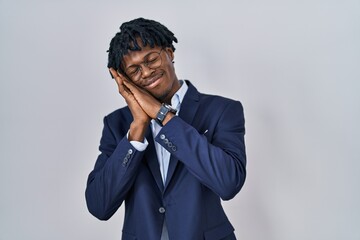 Poster - Young african man with dreadlocks wearing business jacket over white background sleeping tired dreaming and posing with hands together while smiling with closed eyes.