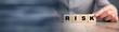 © ARAMYAN - Businessman hold wooden cubes with risk word