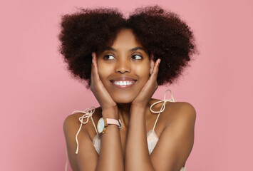 Wall Mural - Portrait of smiling African American woman on pink background