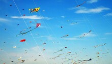 Image Of A Gathering Of Many Colorful Kites On Sunny Day With Blue Sky