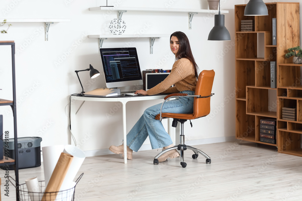 Young female programmer working in office