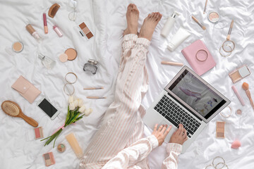 Sticker - Woman with laptop, makeup products and accessories shopping online on white blanket