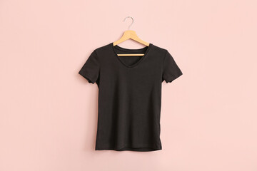 Black t-shirt hanging on pink wall