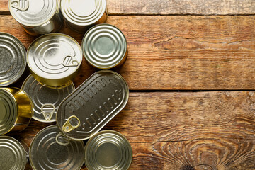 Wall Mural - Assortment of tin cans with fish on wooden table