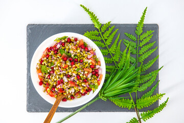 Wall Mural - Sprouting green gram bean Indian salad with Onion, coriander leaf , green chilli , Pomegranate and tomatoes. Indian sprouting gram bean salad with isolated background, Healthy eating concept.