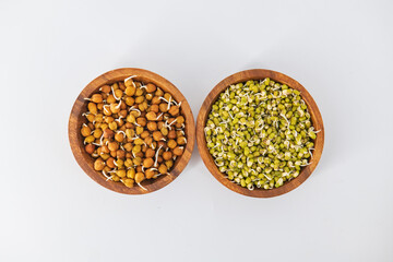 Sprouting green gram bean and sprouting chickpeas in wooden bowl and decorated with an isolated white background. Sprouts are isolated in white background and decorative. ..