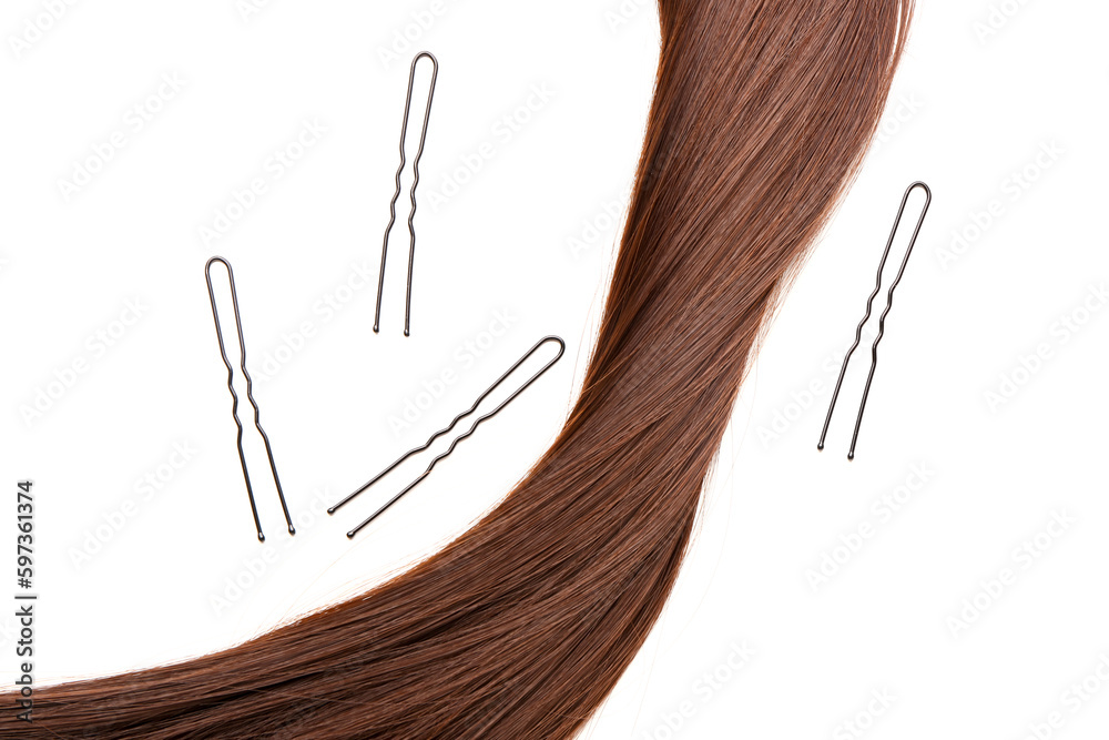Brown hair with pins on white background