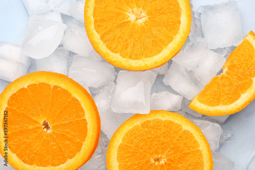 Sliced fresh orange and ice cubes on blue background