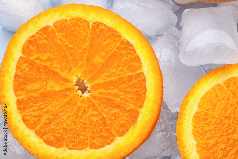 Sliced fresh orange and ice cubes on blue background