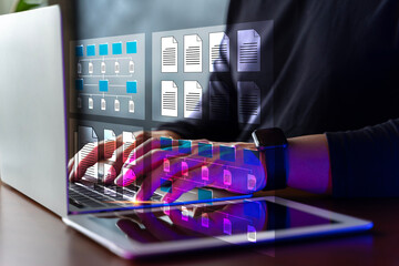 Document management system (DMS) is installed by an IT consultant working on a laptop computer in the office. Ssoftware for archiving.