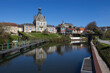 © Imladris - View of the River Somme and Long Town Hall in the village of Long, in the Somme department, near Abbeville in France. Sunny spring day with clear sky and reflections in the still water.