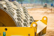 Close up of a sheepsfoot roller compactor, cultivate the soil. The selective focus of roller from use. Poor condition and rusty metal texture after work.
