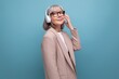 © Ivan Traimak - portrait mature 60s business woman with wireless headphones on bright background with copy space