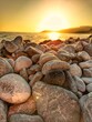 Leinwandbild Motiv sundown on stony beach