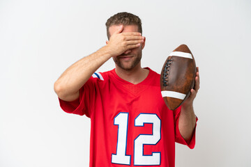 Wall Mural - Young caucasian man playing rugby isolated on white background covering eyes by hands. Do not want to see something