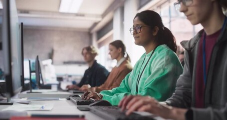 Leinwandbilder - Inspired South Asian Female Student Studying in College with Diverse Multiethnic Classmates. Indian Girl Listening to Teacher, Using Computer to Apply Her Knowledge to Acquire New IT Skills in Class
