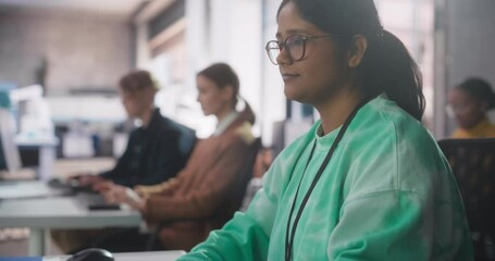 Leinwandbilder - Portrait of a South Asian Female Student Studying in College with Diverse Classmates. Indian Girl Listening to Teacher, Using Computer to Apply Her Knowledge to Acquire New IT Skills in Class