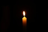 Fototapeta Kawa jest smaczna - One burning wax candle on black background