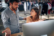 © luckybusiness - Annoyed and angry man and woman arguing over computer desktop at work about project not going well.