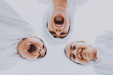 Children playing together in Dubai in the park. Group of kids wearing traditional kandura white dress from arab emirates