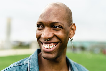 Happy African gay man posing and smiling in front of camera