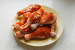 Plate with chicken legs seasoned with red pepper