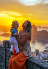 Mother and son tourists at the Dona Marta lookout overlooking the Sugar Loaf Mountain