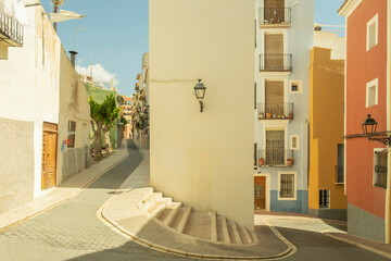 View to beautiful Villajoyosa street with multi-colored houses. Villajoyosa - coastal town in Alicante Province, Valencian Community, Spain, by Mediterranean Sea